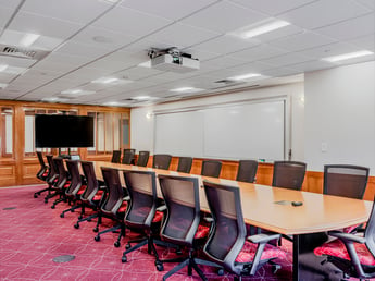 Interior, Percival Hall classroom at Fitchburg State University, Board Room Style table, chairs, whiteboard, monitor, etc.