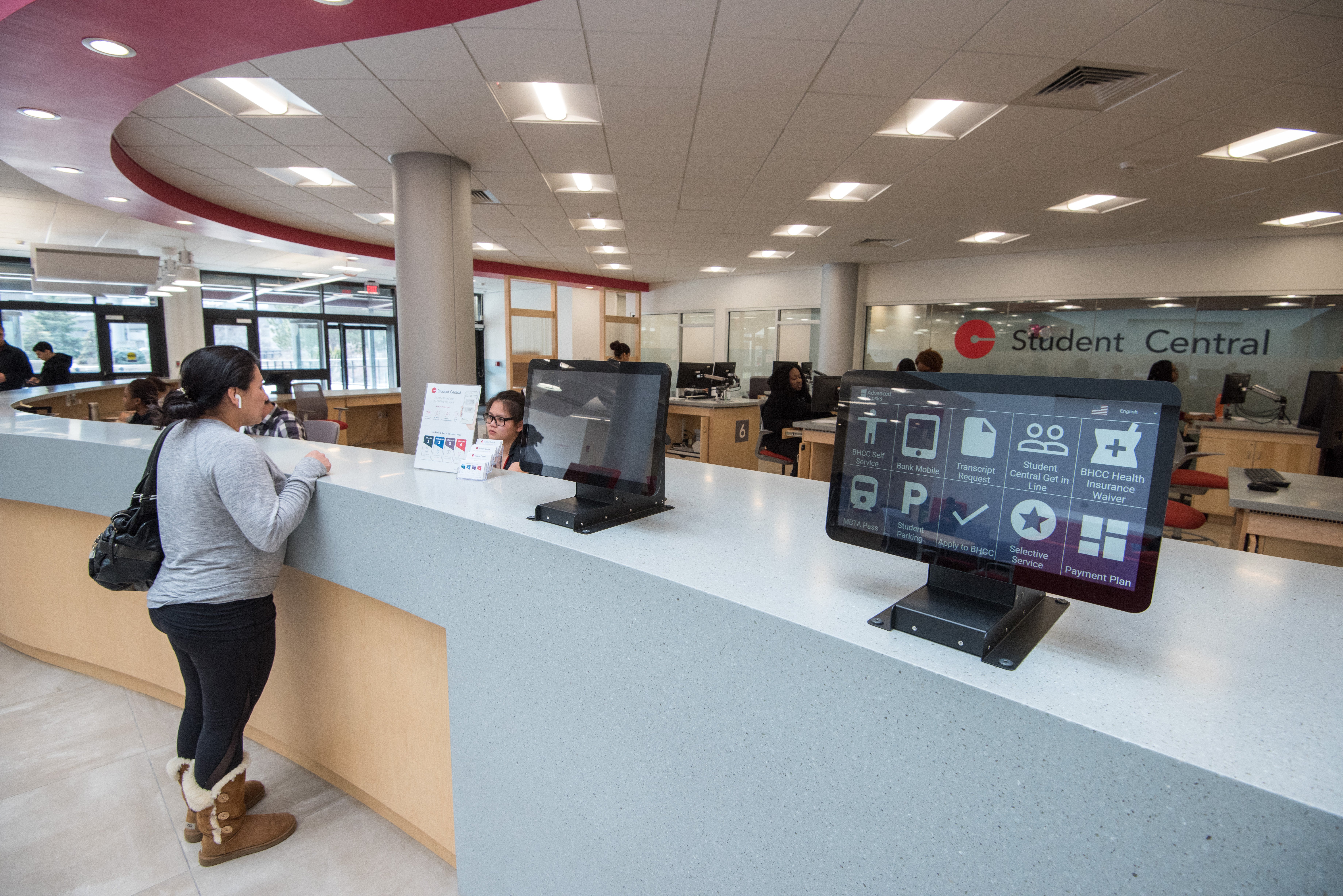 Student Central One Stop student services area at Bunker Hill Community College, student services desks, kiosks, students and staff occupy the space