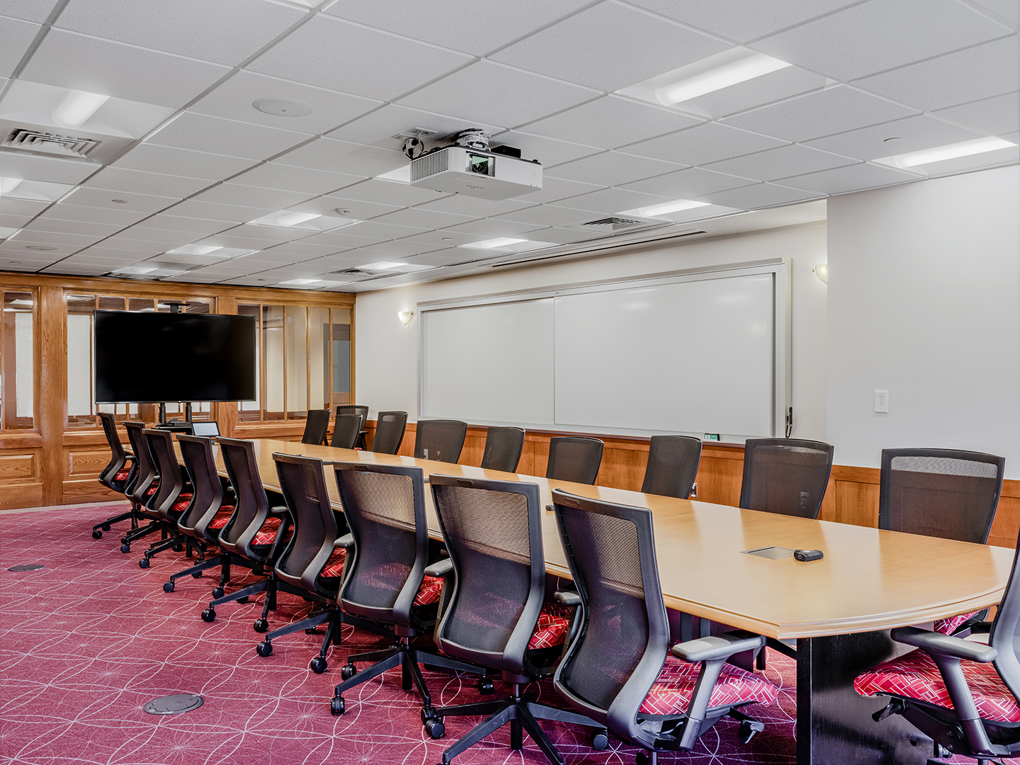 Interior, Percival Hall classroom at Fitchburg State University, Board Room Style table, chairs, whiteboard, monitor, etc.