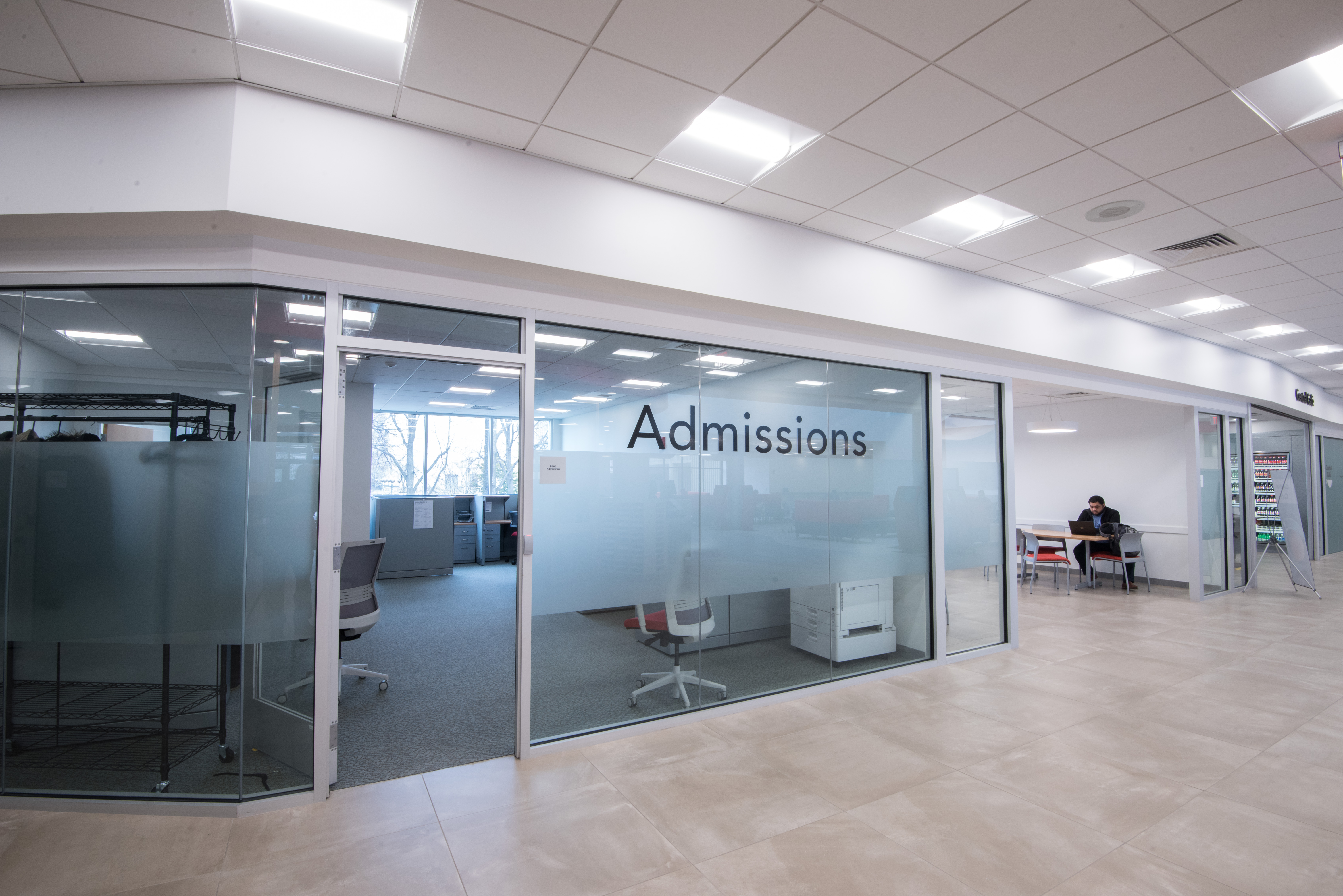 Interior, Student Central Administrative Offices at Bunker Hill Community College, desk cubicles, office chairs, glass pane with "Admissions" on the outside of the office