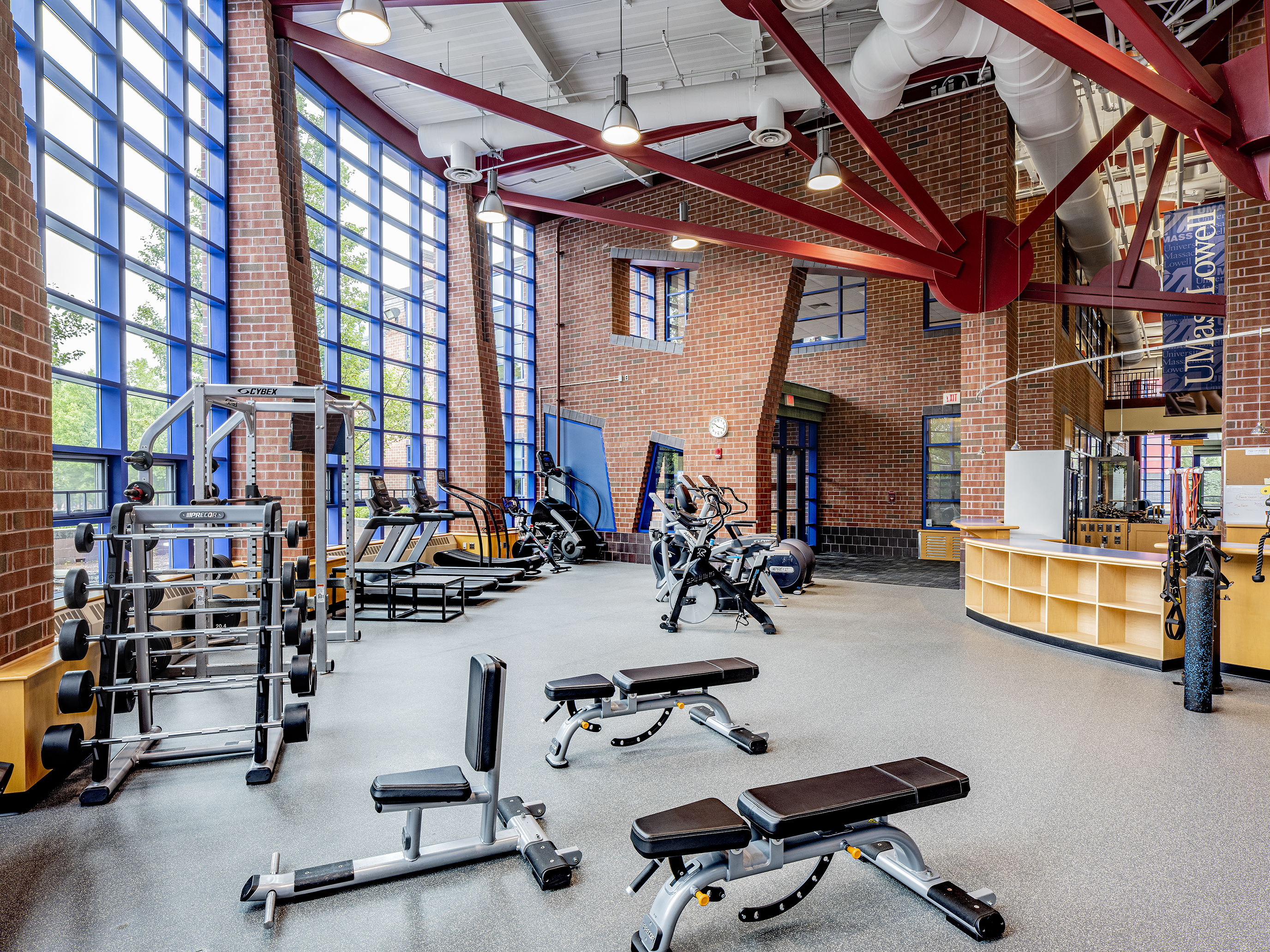 Interior Rec Center Cardio and Guest Services at UMass Lowell, guest services desk, gym equipment